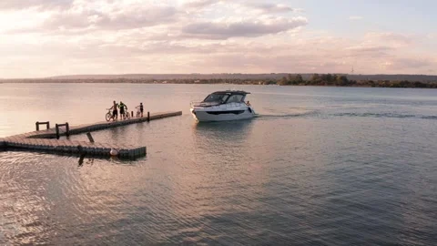 Motorboat approaching a floating dock on Lake Paranoa near Brasilia at sunset Stock Footage 344246753