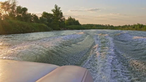 Motorboat creates waves, splashes from the running motors moving at high speed Stock Footage 303047359