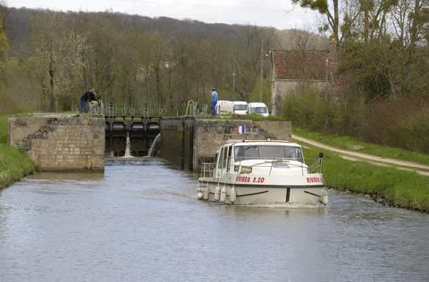 Motorboat leaving the lock at Ecluse 41 Esselier Stock Photos