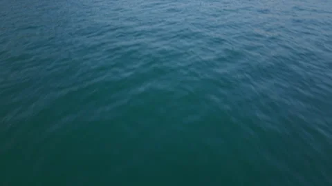 Motorboat Navigating Lake Waters, Mountain Backdrop, Wide Aerial Shot Stock Footage 343680197