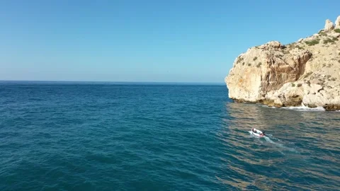 Motorboat Navigating Open Mediterranean Sea Waters Past Moroccan Coast Cliff Stock Footage 345251888