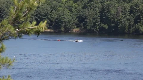 MOTORBOAT PULLS INFLATABLE ACROSS LAKE Video stock 41218014