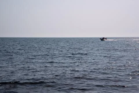 Motorboat riding waves in sea Stock Photos