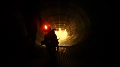 A motorcycle being ridden from inside a jet engine testing exhaust/ muffler, Stock Footage 92072307