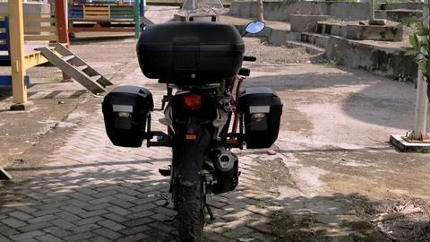 A motorcycle with a black box on the back Stock Photos
