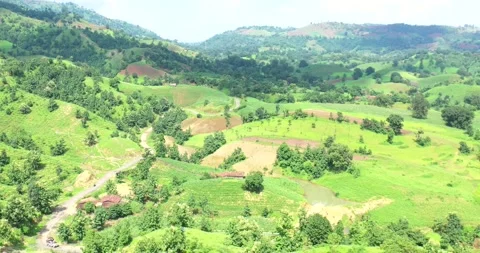 Motorcycle &amp; Car Moving Across Undulating Green Hills In Rural India Stock Footage 154861383