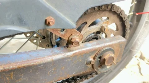 Motorcycle chain that is being lubricated because of rust Stock Footage 306269782