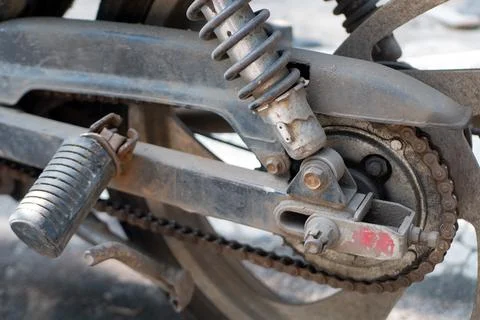 Motorcycle chain is rusty with push step and shockbreaker Stock Photos