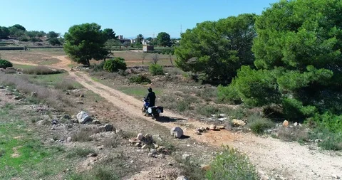 Motorcycle chase drone large displacement trail with suitcases piloting Stock Footage 124365007