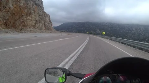 Motorcycle on a cloudy mountain road POV Stock Footage 201245484