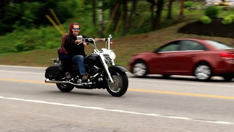Motorcycle couple smiles at camera. Pan view Stock Footage 94010662