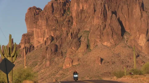Motorcycle on desert road at sunset. 스톡 동영상 24811735