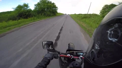 Motorcycle does wheelie into perfect rainbow in sky Stock Footage 64938105