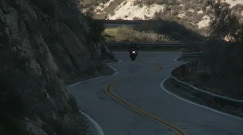 Motorcycle downhill passing car Stock Footage 1064469