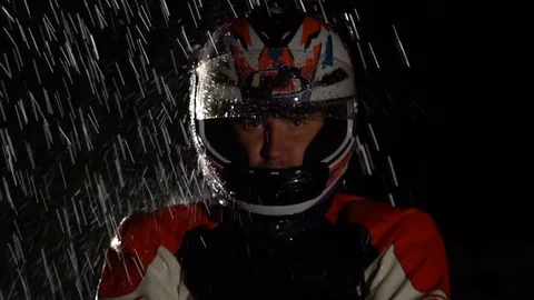 Motorcycle driver in helmet looking at the camera in the rain. Stock Footage 80252513