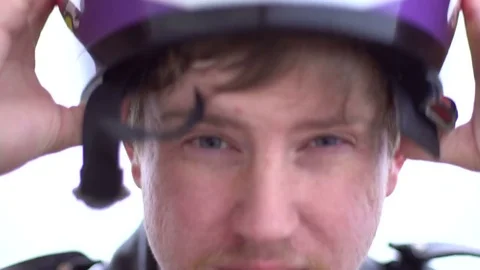 Motorcycle driver puts on his helmet Stock Footage 73657647