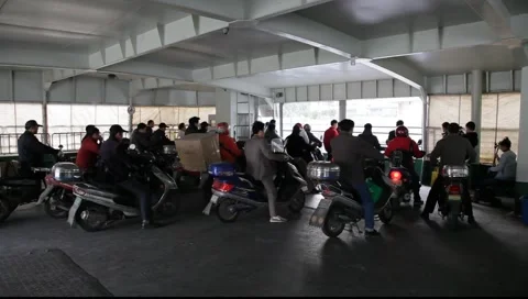 Motorcycle drivers on the ferry, China Stock Footage 1086602