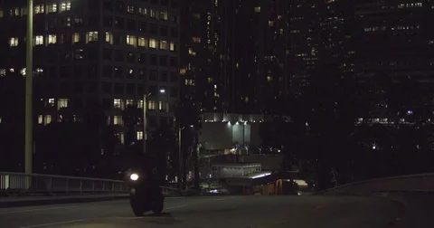 Motorcycle Drives Down an Empty City Road Stock Footage 71788423