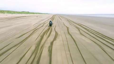 Motorcycle Drives Up Empty Beach Aerial Drone Footage Stock Footage 196983975