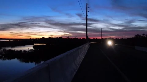 Motorcycle driving over brige at sunset Vídeos de archivo 45290617