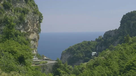 Motorcycle driving on a small winding mountain road Stock Footage 169476020