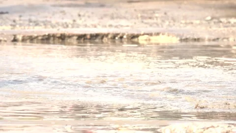 A motorcycle is driving through a muddy road Stock Footage 289316668