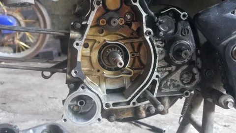 Motorcycle engine being disassembled into the magnet block and cylinder sections Stock Footage 324942086