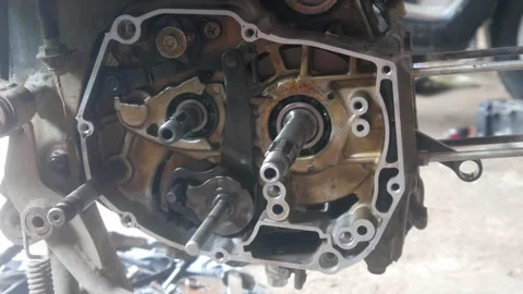 Motorcycle engine being disassembled into the magnet block and cylinder sections Stock Footage 324942154