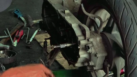 Motorcycle engine repair process with hands working on mechanical parts 스톡 동영상 332126344