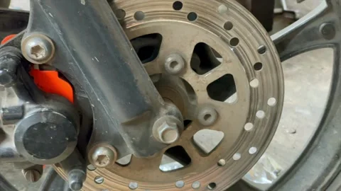 Motorcycle front disc brake system and caliper closeup Stockbeeldmateriaal 344114307