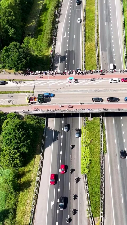 Motorcycle funeral procession escorting a hearse on a highway Stock Footage 327110042