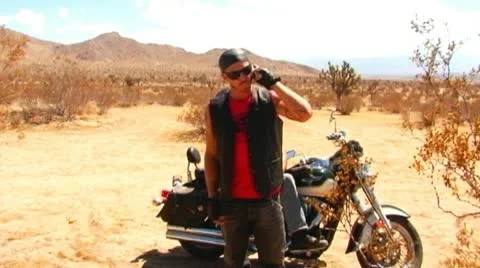 Motorcycle Gang Cell Phone Call In Desert Stock Footage