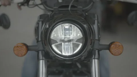Motorcycle headlight turns on Stock Footage 323476312
