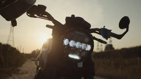 Motorcycle helmet in the rays of the sun somewhere on the off -road Stock Footage 253448861