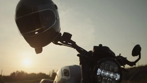 A motorcycle helmet in the sun in the middle of a deserted field Stock Footage 253449931