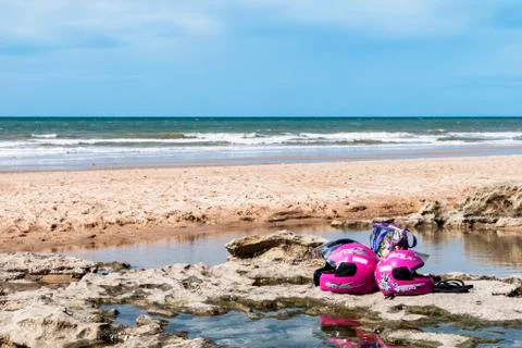 Motorcycle helmets on the beach Stock Photos