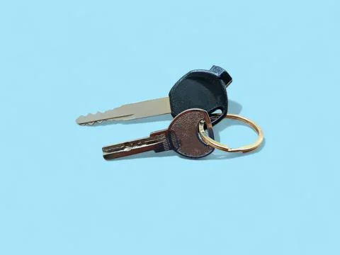 Motorcycle Keys with Keychain Ring Isolated on Blue Background, Vehicle Ignition Stock Photos