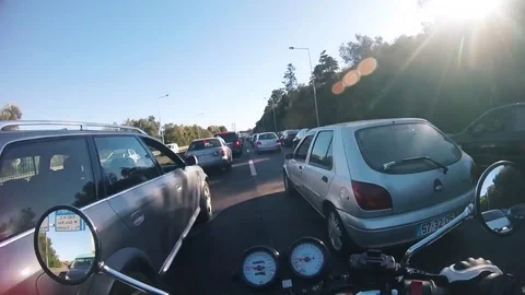 Motorcycle lane splitting in fast forward Stock Footage 84111560