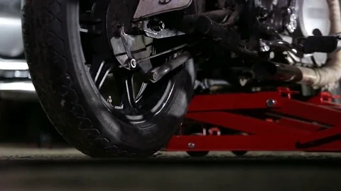 Motorcycle is lifted with hoist in workshop. Video stock 82981055