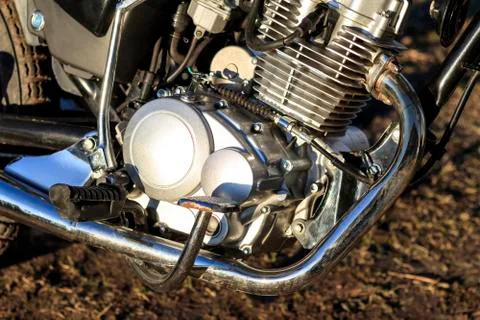 Motorcycle. the main part of the engine. there is dirt on it. close-up. there Stock Photos