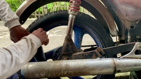Motorcycle Mechanic Changing Tire Stock Footage 324896743