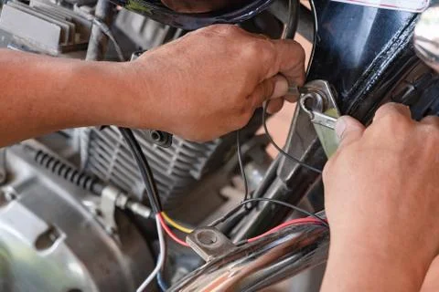 Motorcycle mechanic Installing the interior lighting system Foto stock