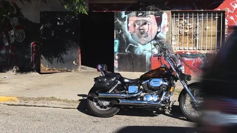 Motorcycle parked in front of a bar 스톡 동영상 130267962