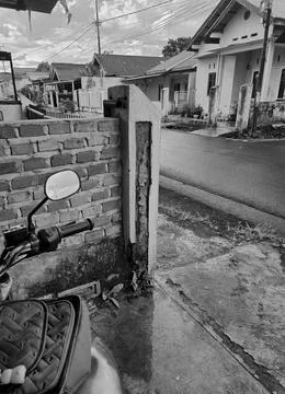 A motorcycle is parked on the side of the road because of the rain Stock Photos