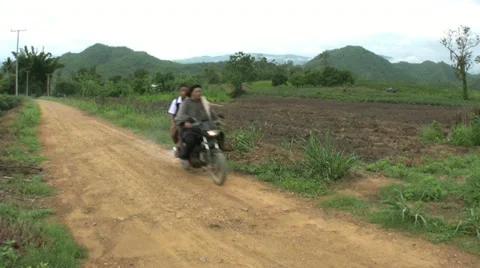 Motorcycle Passes By On Dirt Road 스톡 동영상 10940380
