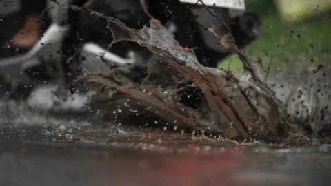 Motorcycle passing damaged road in slow motion water splash 库存影片 345860639