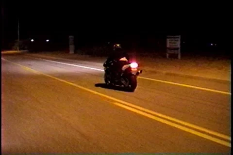 Motorcycle performs a trick called a "stoppie" on a public road Stockbeeldmateriaal 7751753