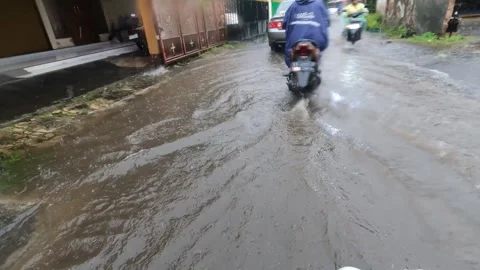 Motorcycle POV Through Congested Yogyakarta Streets in Heavy Rain Stock Footage 321437271