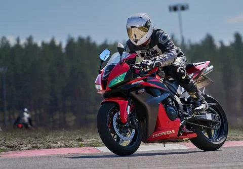 Motorcycle practice leaning into a fast corner on track 스톡 사진