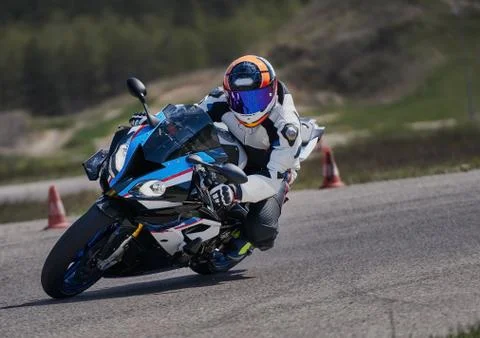 Motorcycle practice leaning into a fast corner on track 库存照片